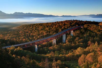 Scenic view of bridge against sky during autumn