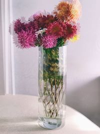 Close-up of flower vase on glass table