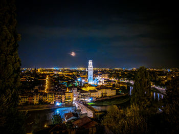 High angle view of illuminated buildings against sky at night