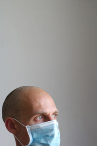 Close-up portrait of a man against gray background