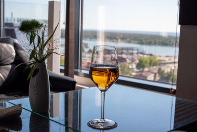 Wine glass on table by window