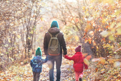 Rear view of woman walking in forest