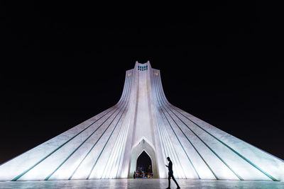 Low angle view of illuminated tower against sky at night