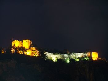 Illuminated building against sky at night