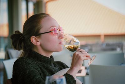 Woman drinking alcoholic drink at restaurant