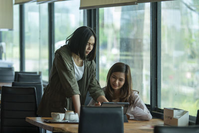 Young woman using laptop at table