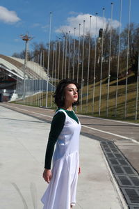 Fashionable woman standing outdoors during sunny day