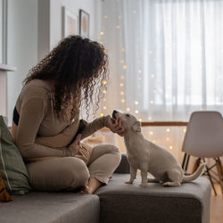 Man with dog sitting at home