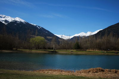 Scenic view of lake and mountains against sky