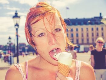 Portrait of young woman eating ice cream