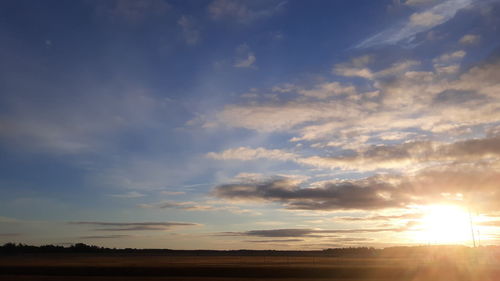 Scenic view of field against sky during sunset