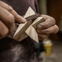 Close-up of man holding wood