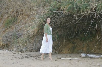 Portrait of young woman standing in water