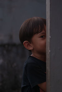 Side view of boy looking away outdoors