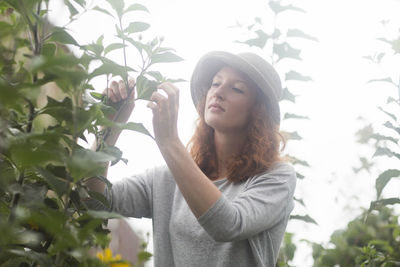 Young woman outside working in an urban garden