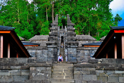 Low angle view of steps amidst trees and building