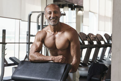 Portrait of shirtless man standing in gym