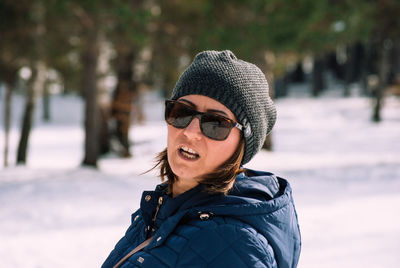 Portrait of smiling young woman in snow