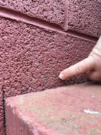 Close-up of hand on wall