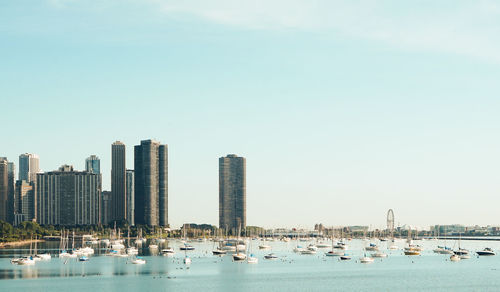 Panoramic view of sea and cityscape against sky