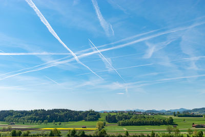 Switzerland, may 11, 2022 contrails formation on a sunny day in spring time
