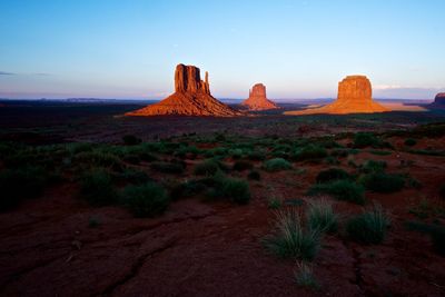 Scenic view of rock formations at monument valley during sunset