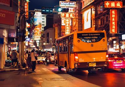 Cars on city street at night