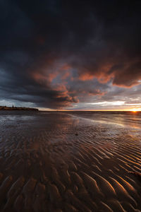 Scenic view of beach against sky during sunset