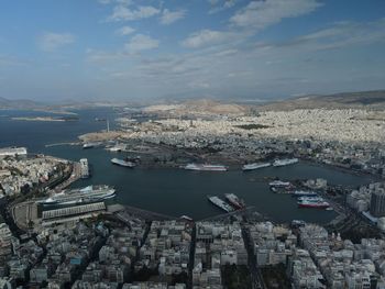 High angle view of townscape by sea against sky