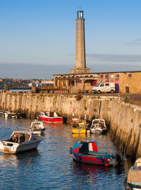 Boats in sea against buildings