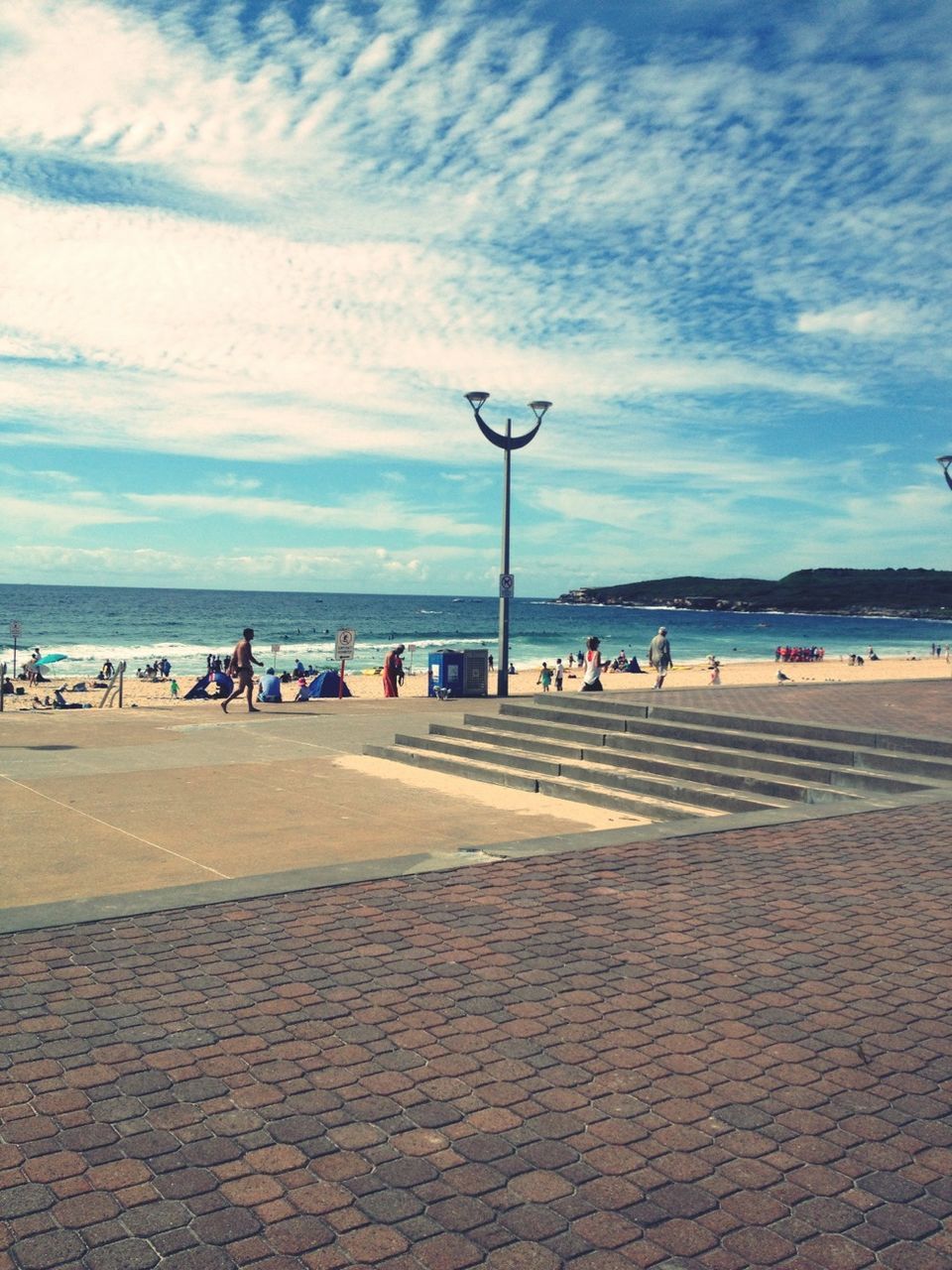 sky, sea, cloud - sky, beach, water, large group of people, cloud, horizon over water, shore, cloudy, scenics, street light, tranquil scene, men, sand, tranquility, incidental people, nature, leisure activity