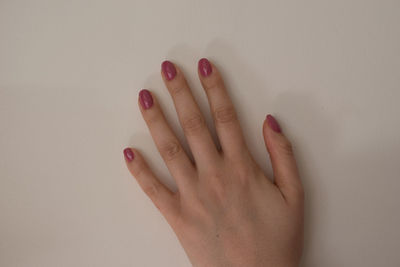 Close-up of woman hand on wall