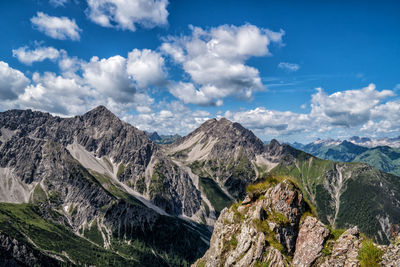 Panoramic view of mountains against cloudy sky