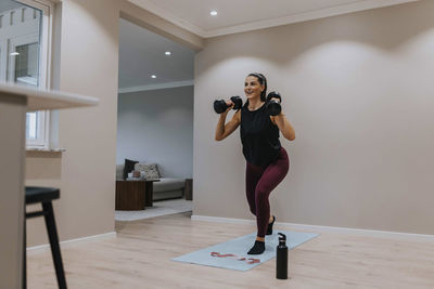 View of woman exercising at home