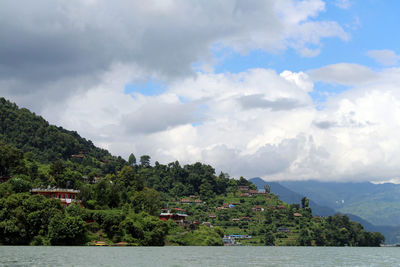 Scenic view of sea and buildings against sky