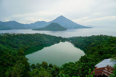 Scenic view of lake and mountains against sky