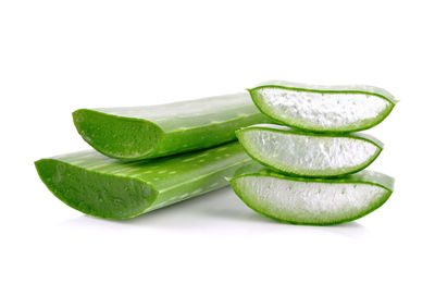 Close-up of green slices over white background