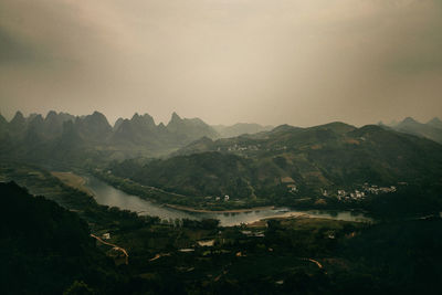 Scenic view of landscape and mountains against sky