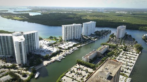 Aerial view of buildings by river in city