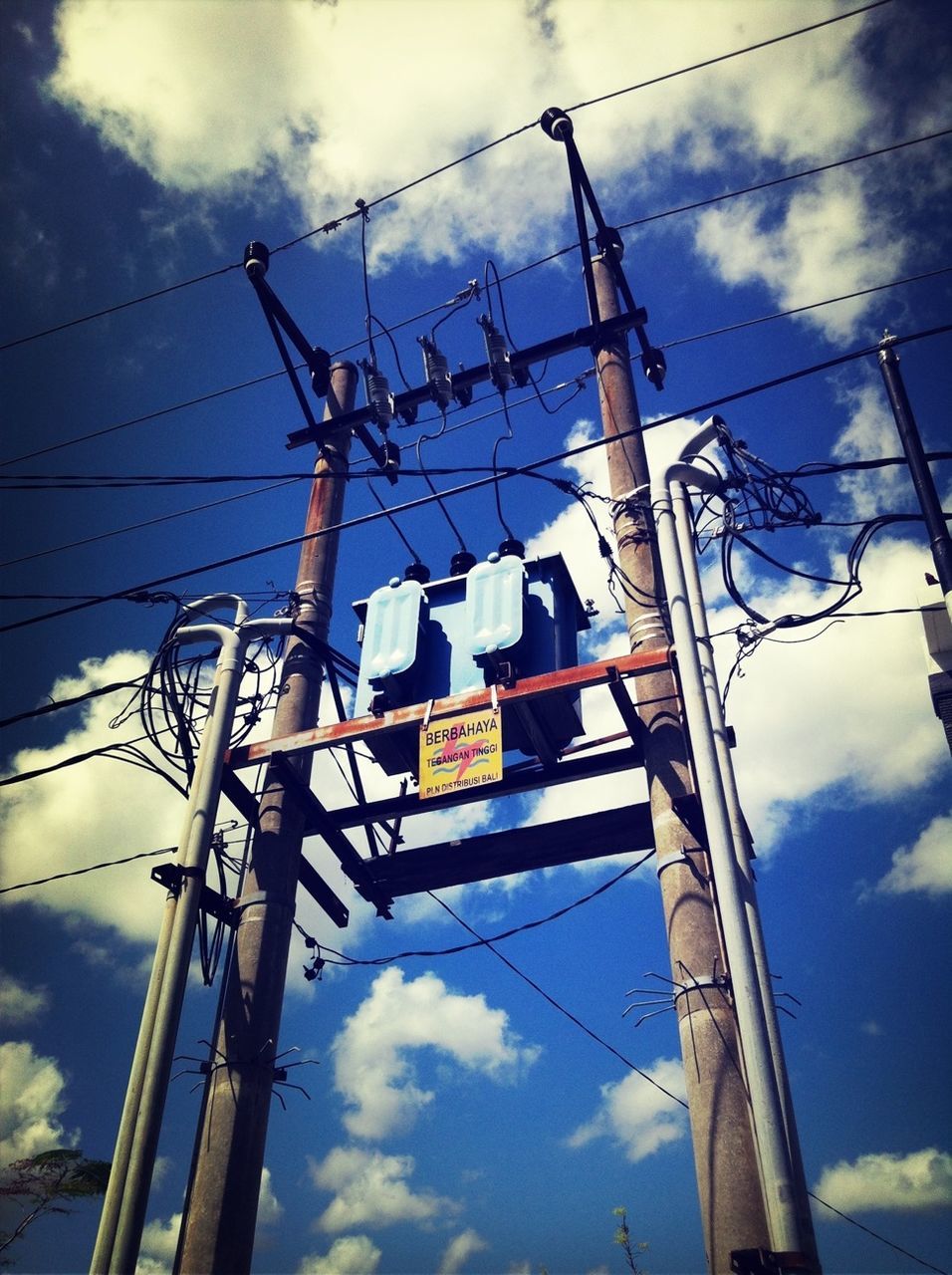 low angle view, power line, sky, electricity, power supply, electricity pylon, cable, cloud - sky, connection, fuel and power generation, technology, cloudy, blue, cloud, pole, power cable, communication, day, no people, lighting equipment