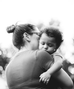 Mother embracing son outdoors