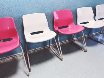 Empty chairs against wall