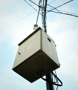 Low angle view of telephone pole against sky