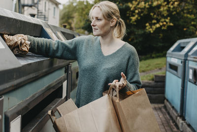 Woman recycling rubbish