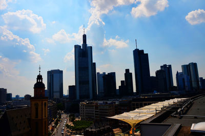 Cityscape against cloudy sky