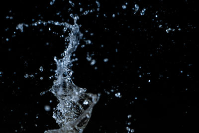 Close-up of water splashing against black background