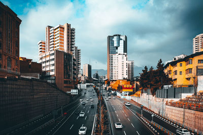 Panoramic view of city street and buildings against sky