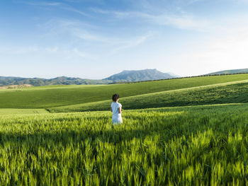 Woman in a crop field in ardales, malaga, spain