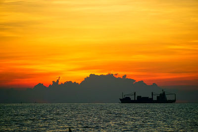 Scenic view of sea against orange sky