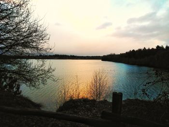 Scenic view of lake against sky at sunset